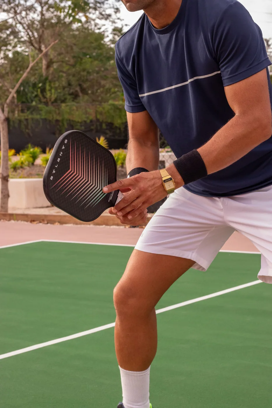 Player lining up a shot with a pickleball paddle on an outdoor court